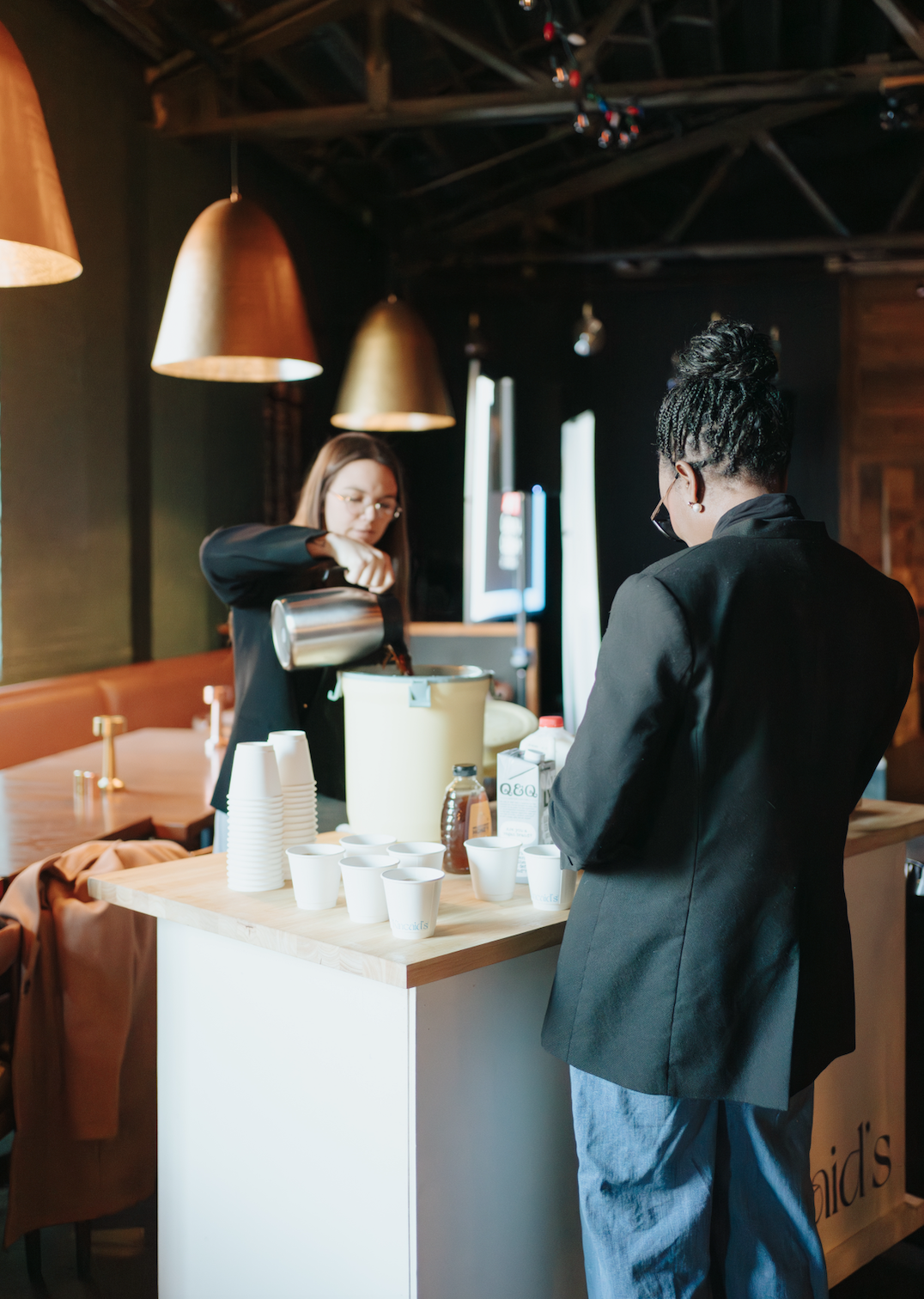 Barista pouring milk at a corporate event